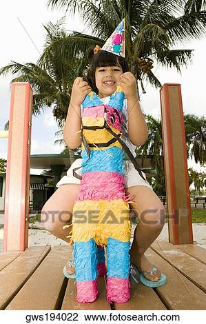 Portrait of a girl sitting on a rocking horse and smiling View Large Photo Image Stock Image - Portrait of a girl sitting on a rocking horse and smiling. Fotosearch
