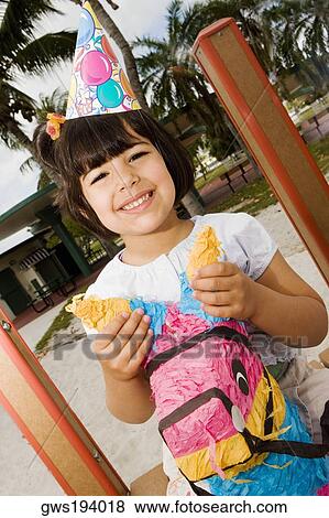 Portrait of a girl sitting on a rocking horse and smiling View Large Photo Image Stock Photo - Portrait of a girl sitting on a rocking horse and smiling. Fotosearch