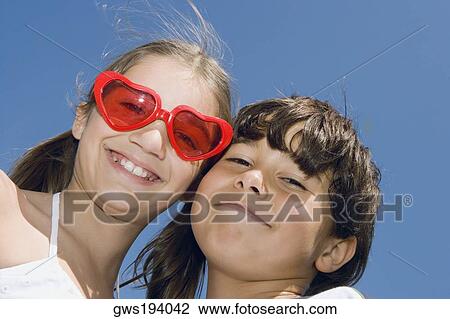 Portrait of a girl smiling with her brother View Large Photo Image Stock Image - Portrait of a girl smiling with her brother. Fotosearch