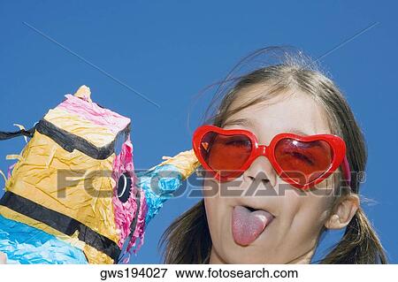 Portrait of a girl sticking her tongue out View Large Photo Image Stock Photo - Portrait of a girl sticking her tongue out. Fotosearch