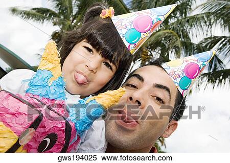 Portrait of a mid adult man and his daughter sticking their tongues out View Large Photo Image Stock Photography - Portrait of a mid adult man and his daughter sticking their tongues out. Fotosearch