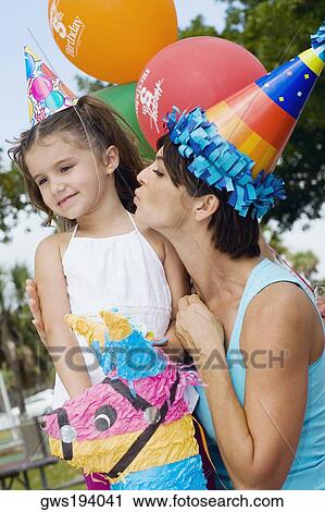 Side profile of a mid adult woman kissing her daughter View Large Photo Image Stock Image - Side profile of a mid adult woman kissing her daughter. Fotosearch