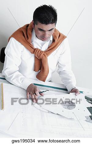 Picture - Architect drawing a blueprint in an office. Fotosearch