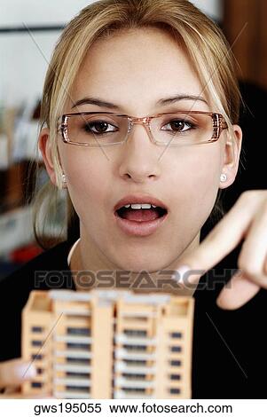 Close-up of a female architect holding an architectural model and pointing View Large Photo Image Stock Photography - Close-up of a female architect holding an architectural model and pointing. Fotosearch