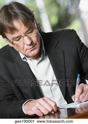 Close-up of a mature man writing on a sheet of paper View Large Photo Image Stock Image - Close-up of a mature man writing on a sheet of paper. Fotosearch