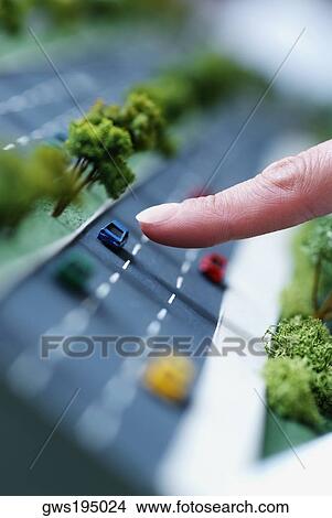 Close-up of a person's finger pointing to an architectural model of a highway View Large Photo Image Picture - Close-up of a person's finger pointing to an architectural model of a highway. Fotosearch