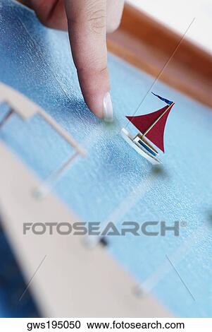 Close-up of a person's finger pointing to an architectural model of a sailboat View Large Photo Image Stock Image - Close-up of a person's finger pointing to an architectural model of a sailboat. Fotosearch