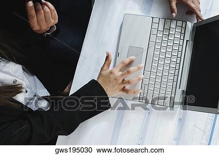 Stock Image - High angle view of a businesswoman using a laptop. Fotosearch