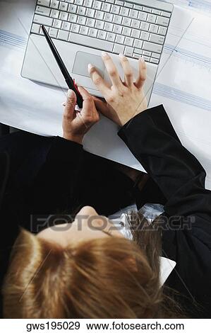 High angle view of a businesswoman using a laptop View Large Photo Image Stock Photo - High angle view of a businesswoman using a laptop. Fotosearch