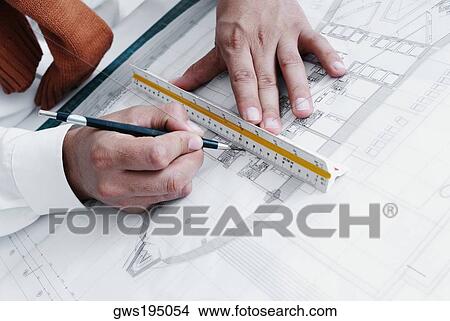 Picture - High angle view of a person's hand drawing a blueprint. Fotosearch