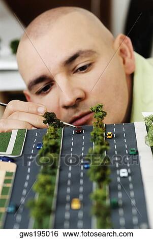Male architect making an architectural model of a highway View Large Photo Image Stock Photograph - Male architect making an architectural model of a highway. Fotosearch