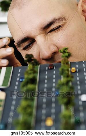 Male architect making an architectural model of a highway View Large Photo Image Stock Photography - Male architect making an architectural model of a highway. Fotosearch