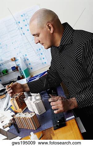 Side profile of an architect working in an office View Large Photo Image Stock Photo - Side profile of an architect working in an office. Fotosearch