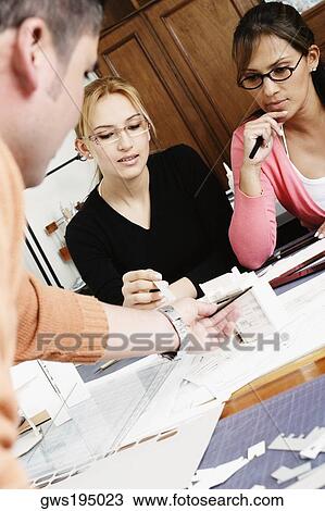 Three architects discussing an architectural model View Large Photo Image Stock Image - Three architects discussing an architectural model. Fotosearch