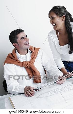 Stock Photo - Two architects laughing in an office. Fotosearch