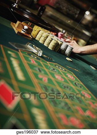 Casino worker's hand arranging gambling chips on a gambling table View Large Photo Image Stock Photo - Casino worker's hand arranging gambling chips on a gambling table. Fotosearch