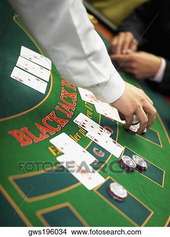 Casino worker's hand placing gambling chips on a gambling table View Large Photo Image Picture - Casino worker's hand placing gambling chips on a gambling table. Fotosearch
