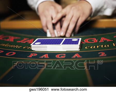 Close-up of a casino worker's hand shuffling playing cards on a gambling table View Large Photo Image Stock Image - Close-up of a casino worker's hand shuffling playing cards on a gambling table. Fotosearch