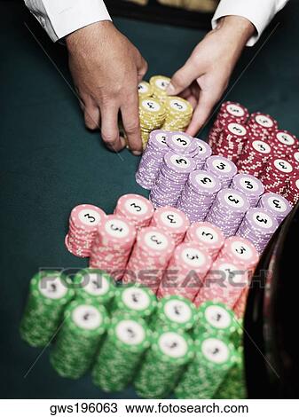 Close-up of a casino worker's hand arranging gambling chips on a gambling table View Large Photo Image Stock Image - Close-up of a casino worker's hand arranging gambling chips on a gambling table. Fotosearch