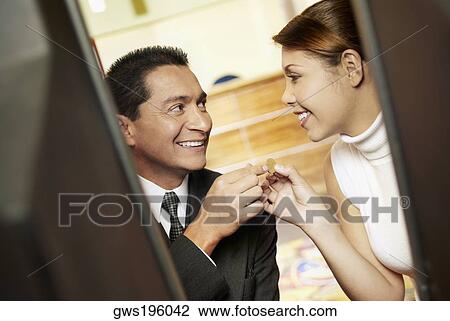 Close-up of a mature man with his daughter looking at each other and smiling View Large Photo Image Stock Image - Close-up of a mature man with his daughter looking at each other and smiling. Fotosearch