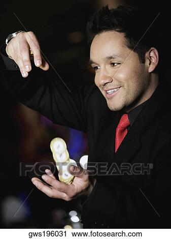Close-up of a mid adult man playing with gambling chips in a casino View Large Photo Image Stock Image - Close-up of a mid adult man playing with gambling chips in a casino. Fotosearch
