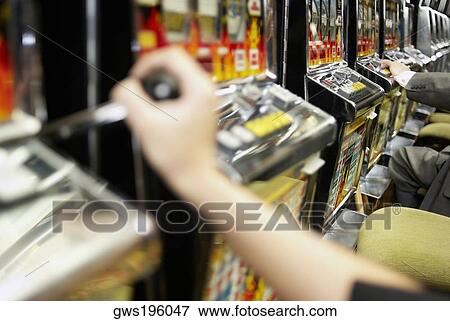 Close-up of a person's hand holding the lever of a slot machine View Large Photo Image Stock Photo - Close-up of a person's hand holding the lever of a slot machine. Fotosearch