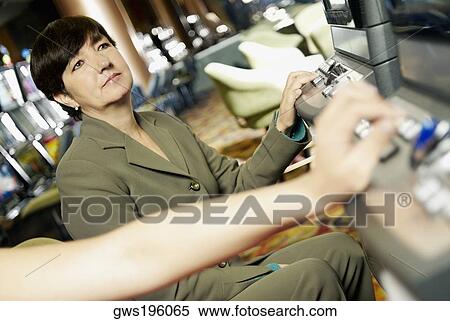 Close-up of a person's hand on a slot machine with a mature woman looking at it View Large Photo Image Stock Photography - Close-up of a person's hand on a slot machine with a mature woman looking at it. Fotosearch