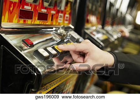 Close-up of a person's hand playing on a slot machine View Large Photo Image Stock Photo - Close-up of a person's hand playing on a slot machine. Fotosearch