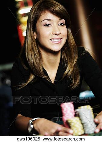 Close-up of a young woman holding stacks of gambling chips on a gambling table View Large Photo Image Stock Photography - Close-up of a young woman holding stacks of gambling chips on a gambling table. Fotosearch