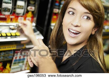 Close-up of a young woman playing on a slot machine at a casino View Large Photo Image Stock Image - Close-up of a young woman playing on a slot machine at a casino. Fotosearch