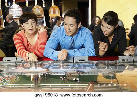 Mature woman with a mid adult man and a teenage girl leaning on a casino View Large Photo Image Stock Photo - Mature woman with a mid adult man and a teenage girl leaning on a casino. Fotosearch