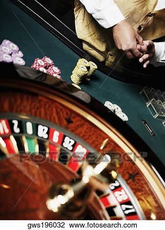 Mid section view of a casino worker standing at a roulette table View Large Photo Image Stock Image - Mid section view of a casino worker standing at a roulette table. Fotosearch