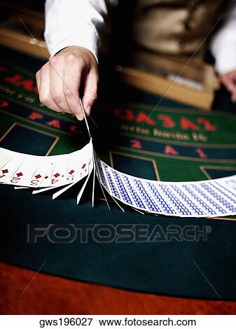 Mid section view of a casino worker's hand dealing with playing cards on a gambling table View Large Photo Image Stock Photo - Mid section view of a casino worker's hand dealing with playing cards on a gambling table. Fotosearch