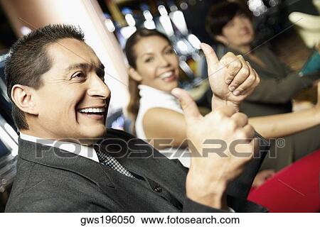 Side profile a mature man showing a thumbs up sign with his daughter beside him at a casino View Large Photo Image Stock Image - Side profile a mature man showing a thumbs up sign with his daughter beside him at a casino. Fotosearch