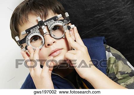 Close-up of a boy wearing phoropter in a doctor's office View Large Photo Image Stock Image - Close-up of a boy wearing phoropter in a doctor's office. Fotosearch
