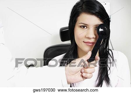 Close-up of a doctor's hand examining a young woman's eye View Large Photo Image Stock Image - Close-up of a doctor's hand examining a young woman's eye. Fotosearch