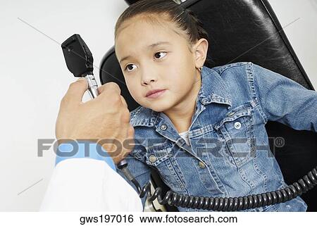 Close-up of a doctor's hand examining a girl's eye View Large Photo Image Stock Photograph - Close-up of a doctor's hand examining a girl's eye. Fotosearch