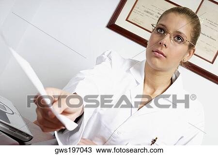 Stock Image - Close-up of a female doctor giving a report. Fotosearch