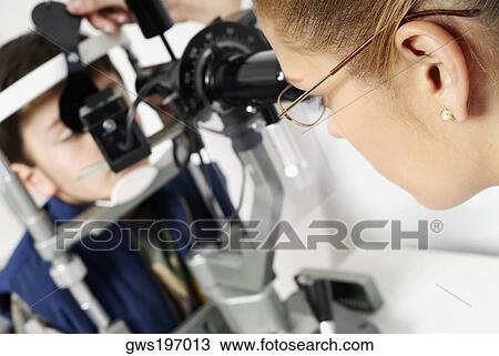 Close-up of a female optometrist examining eyes of a boy View Large Photo Image Stock Image - Close-up of a female optometrist examining eyes of a boy. Fotosearch
