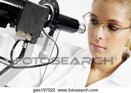 Close-up of a female optometrist looking through an ophthalmometer View Large Photo Image Stock Image - Close-up of a female optometrist looking through an ophthalmometer. Fotosearch