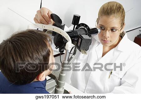 Close-up of a female optometrist examining eyes of a boy View Large Photo Image Stock Image - Close-up of a female optometrist examining eyes of a boy. Fotosearch