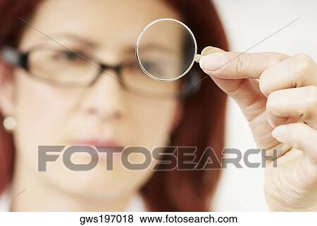 Close-up of a female optometrist holding a lens View Large Photo Image Stock Photo - Close-up of a female optometrist holding a lens. Fotosearch