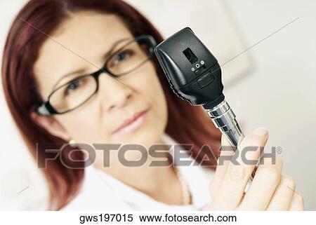 Close-up of a female optometrist holding an eye test equipment View Large Photo Image Stock Photography - Close-up of a female optometrist holding an eye test equipment. Fotosearch
