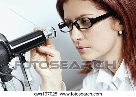 Close-up of a female optometrist using a phoropter View Large Photo Image Stock Photography - Close-up of a female optometrist using a phoropter. Fotosearch