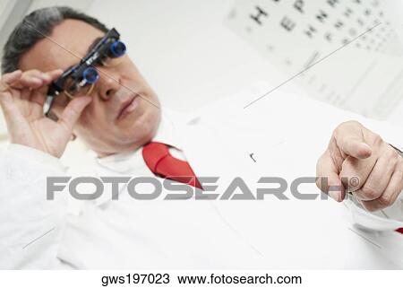 Close-up of a male doctor using lupa binoculars View Large Photo Image Stock Image - Close-up of a male doctor using lupa binoculars. Fotosearch