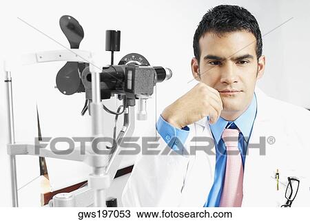 Close-up of a male optometrist thinking with his hand on his chin View Large Photo Image Stock Image - Close-up of a male optometrist thinking with his hand on his chin. Fotosearch