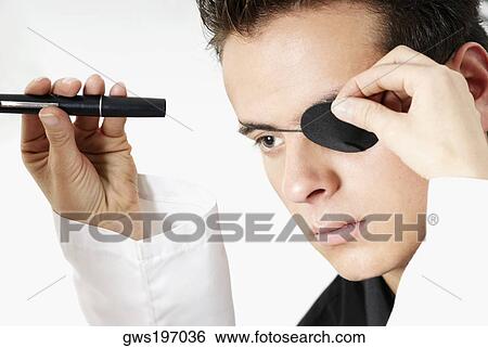 Stock Photograph - Optometrist examining a young man's eye. Fotosearch