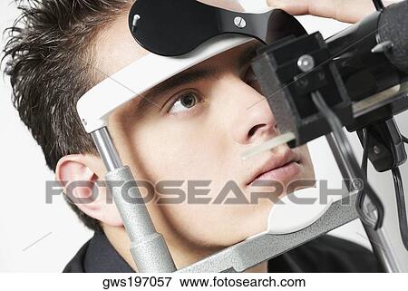 Stock Photo - Young man having an eye test. Fotosearch