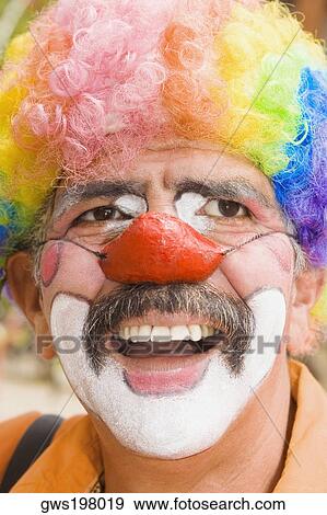 Stock Photo - Close-up of a circus clown with a red nose and laughing. Fotosearch