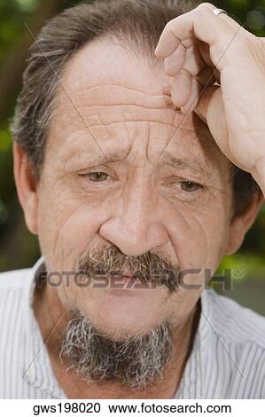 Stock Image - Close-up of a mature man looking serious. Fotosearch